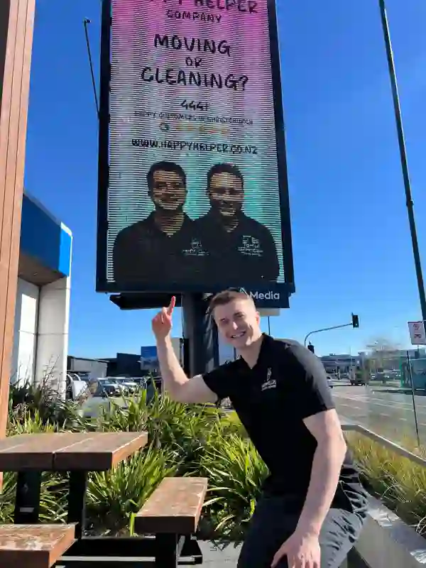 Pointing at our Happy Helper billboard