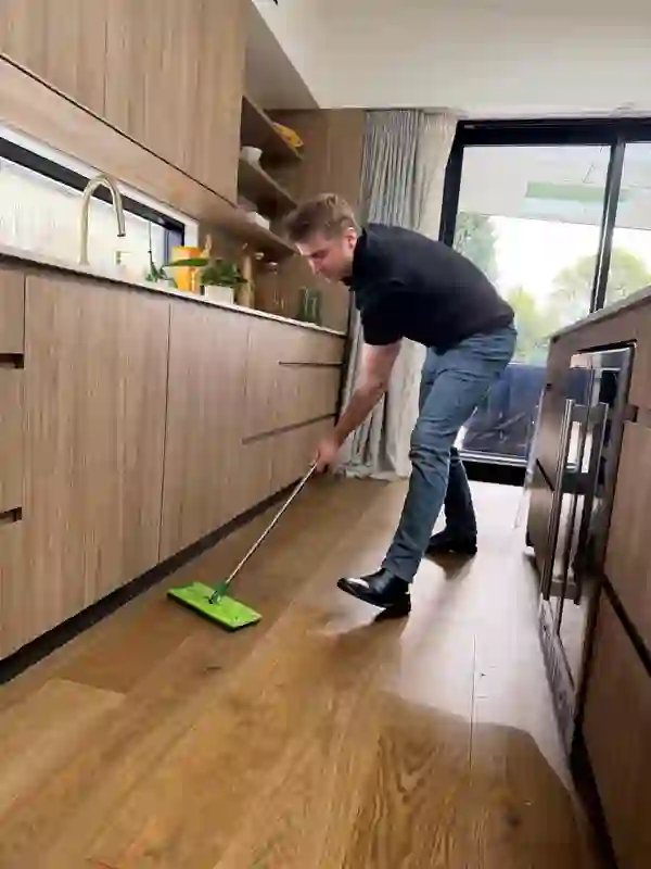 Happy Helper mopping a timber kitchen floor