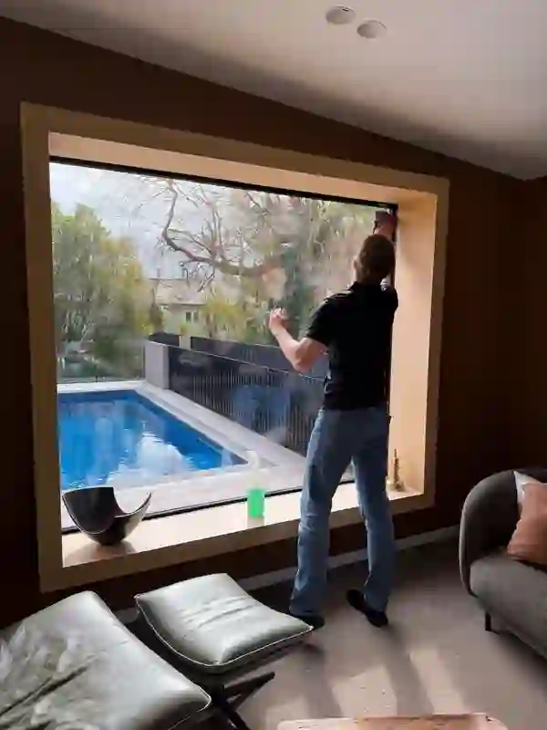 Happy Helper cleaning a large window